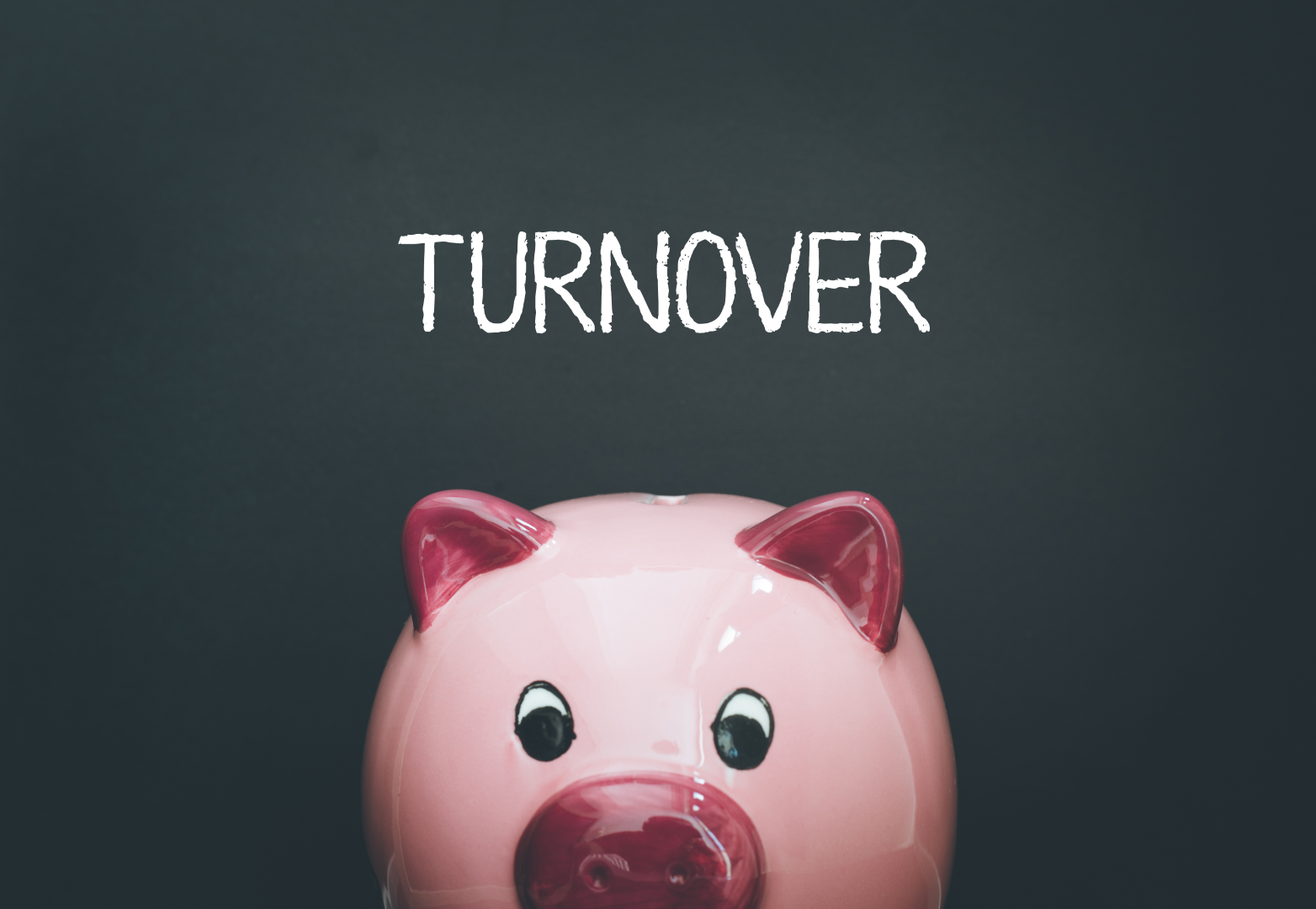 Pink piggy bank on black chalk board that says Turnover