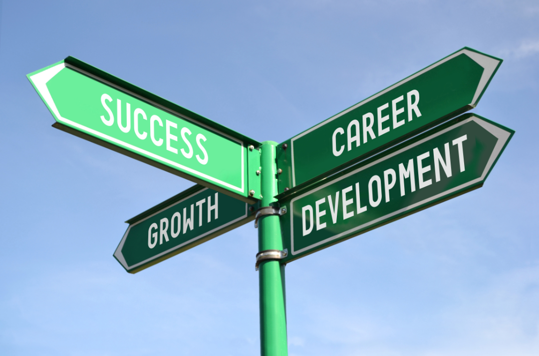 image of a street sign with the words success, career, development and growth