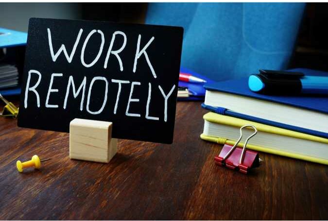 sign on mini chalk board with work remotely written on it